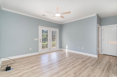 Spare room with ceiling fan, ornamental molding, a