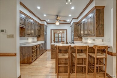 Kitchen with a kitchen bar, light hardwood / wood-