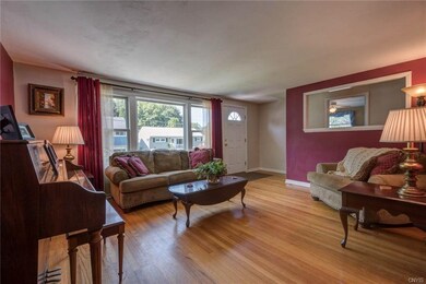 The living room features a large picture window, h
