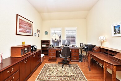 Working at home will be a pleasure in this warm, inviting study with hardwood flooring, high ceilings and dual shuttered windows.
