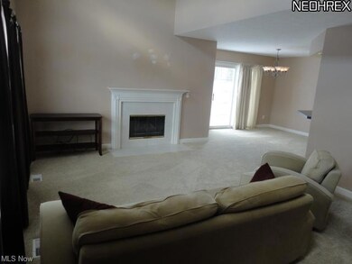 Great room with fireplace opens to dining room.
