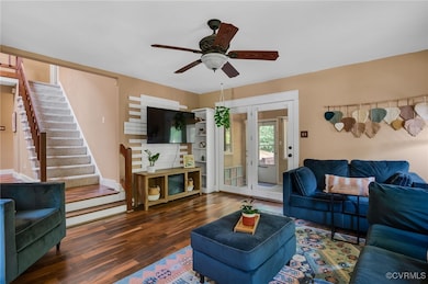 Living area with wood finished floors, stairs, cei
