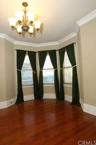 Living room/parlor with crown molding and wood flo