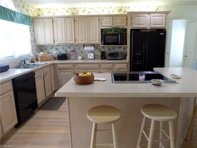 Sizeable kitchen w/ open floor plan features island w/ seating, office area & sitting room
