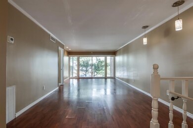 Empty room with ornamental molding and dark wood-t