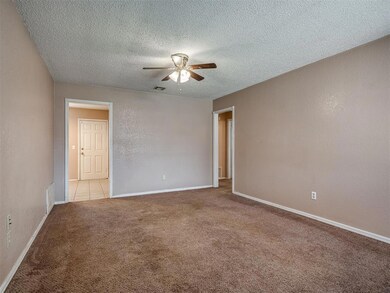 Spare room with light colored carpet, ceiling fan,