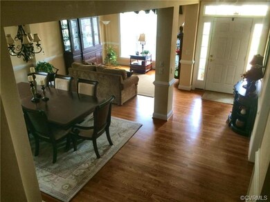 Formal WOW entry with beautiful hardwood floors! T
