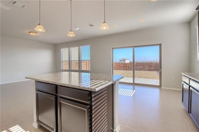 Kitchen featuring baseboards, decorative light fi
