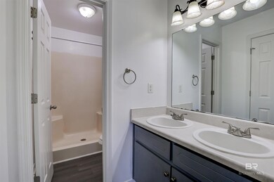 Bathroom featuring a shower, vanity, toilet, and wood-type flooring