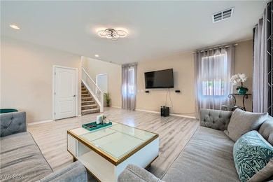 Living room featuring stairway, wood finished floo