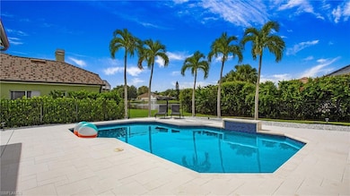 View of swimming pool with fence and a patio