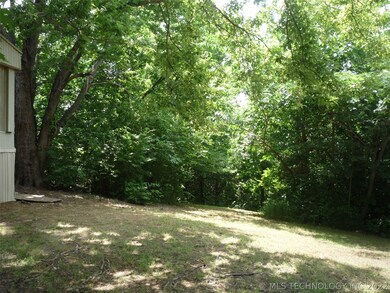 View looking west at wooded area