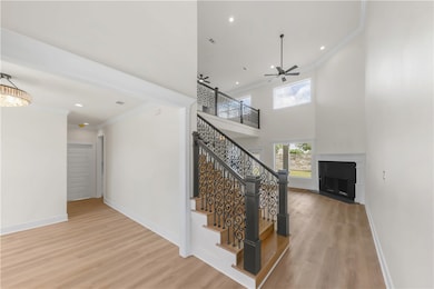 Stairs with ornamental molding, a ceiling fan, woo