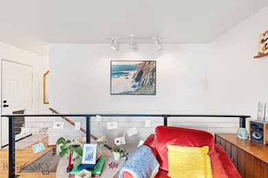 View of stairs in sitting room with wood-style flo