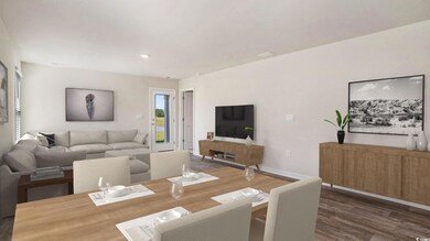 Virtually staged Dining space with dark wood-type flooring and baseboards