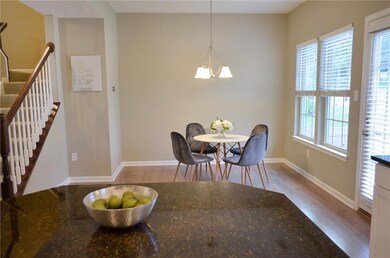 Bright dining room with door to back patio