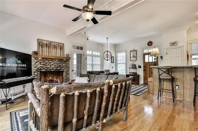 Living room featuring ceiling fan with notable cha