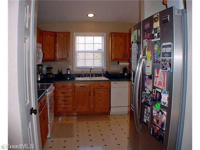 Kitchen. Yes, there s a separate pantry in this warm and functional kitchen.  It s all here --  smooth top range, over the stove microwave, dishwasher and disposer. Note plenty of space to accommodate a side-by-side refrigerator/freezer.