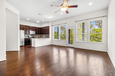 Unfurnished living room with a sink, ceiling fan,