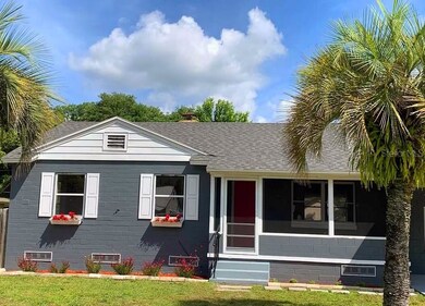 Well appointed with window boxes, red front door a