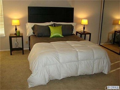 Master bedroom with mirrored wardrobe.