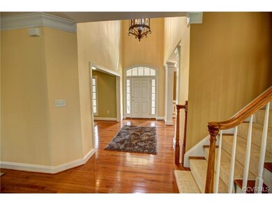 Two-story gracious entryway with sidelights, arche