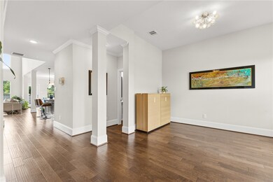 Unfurnished room with dark wood-style flooring, ornamental molding, and recessed lighting