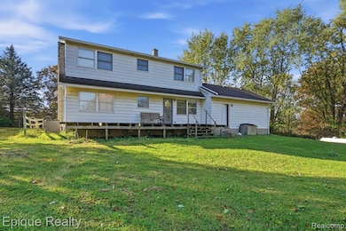 Rear view of house with a lawn and a chimney