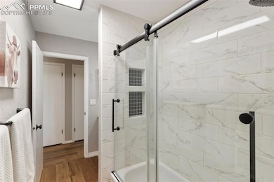 Full hallway Bathroom with a glass shower door