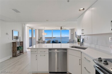 Kitchen with white cabinets, a water view, hanging