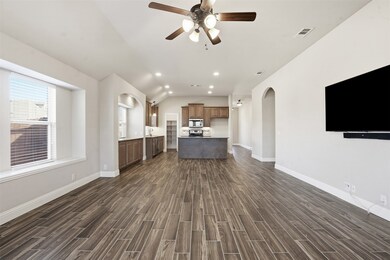 Unfurnished living room with recessed lighting, arched walkways, a ceiling fan, vaulted ceiling, and wood tiled floors