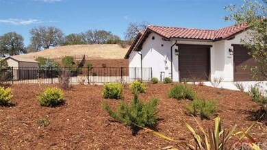 Side yard with wrought iron fence.
