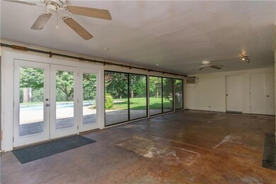 Sunroom with large windows to look out on pool and