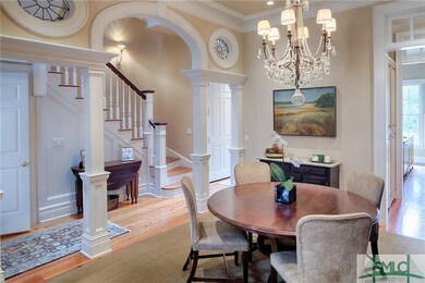 Dining room with curved archway and pair of oculus