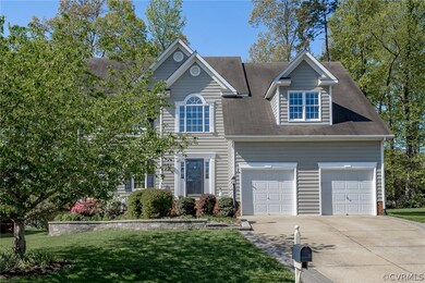 Vinyl Siding, Paver Lined Concrete Driveway, Two Car Front Entry Garage, Stone Retaining Wall surrounds the lovely landscaping near the Front Entryway! Lovely setting, beautiful landscaping along this entire street!