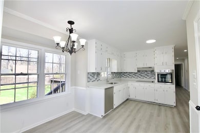 Kitchen featuring light countertops, stainless ste
