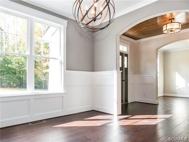 formal dining room with wainscoting and crown mold