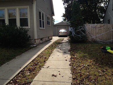 Exterior Back. Extra long driveway comfortably fit