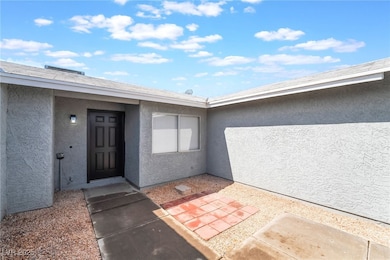 Doorway to property featuring stucco siding