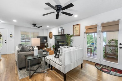 Here’s another view of the living room facing the front door, offering a glimpse of your enclosed patio and beautiful front yard. The space feels so light, open, and airy.