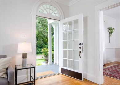 The front entryway is flooded with natural light, 