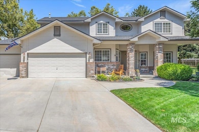 View of front facade with covered porch, an attached garage, concrete driveway, a front yard, and brick siding