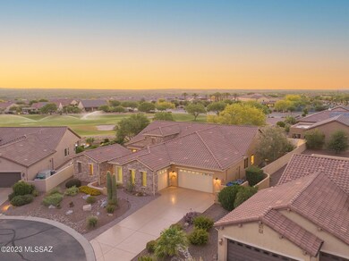 Ariel of home, golf course and sunset.