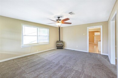spacious living room with new carpet and fireplace