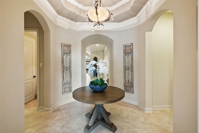 As you step inside and walk through the beautiful rotunda with high tray ceilings, you will find yourself entering the palatial common areas of the home with soaring ceilings all the way from the kitchen across to the living room.