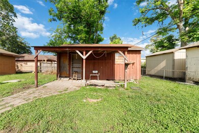 This photo features a backyard with a small wooden
