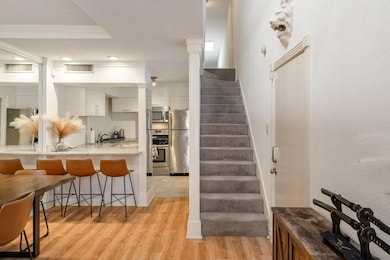 Stairs featuring decorative columns, wood finished