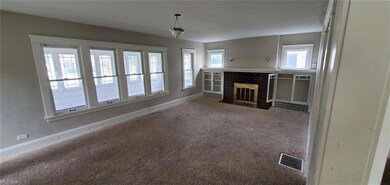Carpeted living room featuring a fireplace