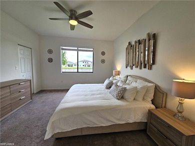 Bedroom featuring baseboards, dark colored carpet,