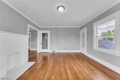 Unfurnished living room with ornamental molding, light hardwood / wood-style floors, and a fireplace